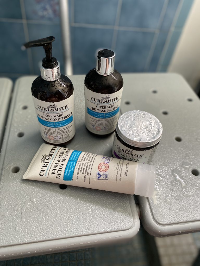 Curlsmith Products on a shower bench