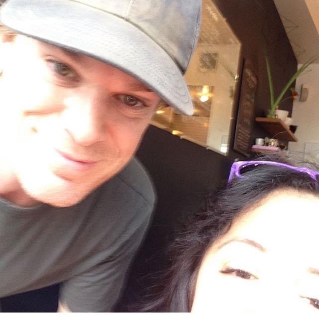 Actor Michael C Hall and I are looking into the camera. He is wearing a greyish t shirt and basecall cap.