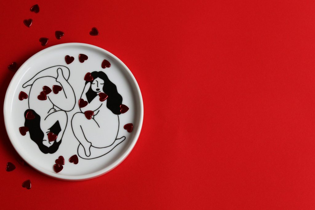 Red background with two drawn females 