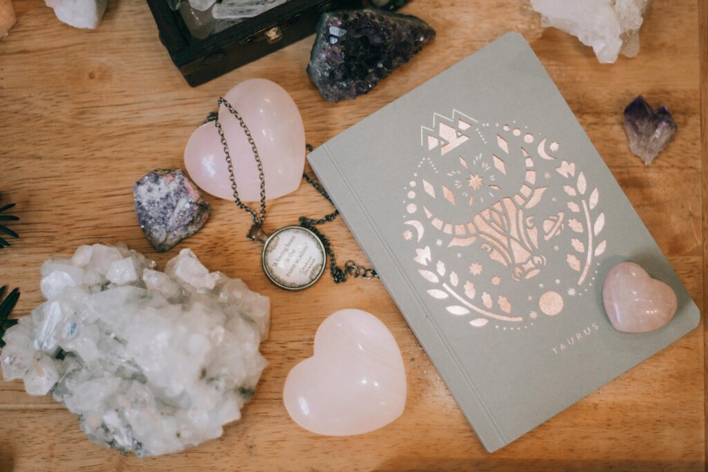 May horoscope. Taurus card, crystals, two crystals in the shape of hearts. Bird's eye view.