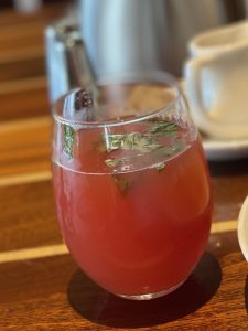 Refreshing glass of basil and watermelon juice on a table. 