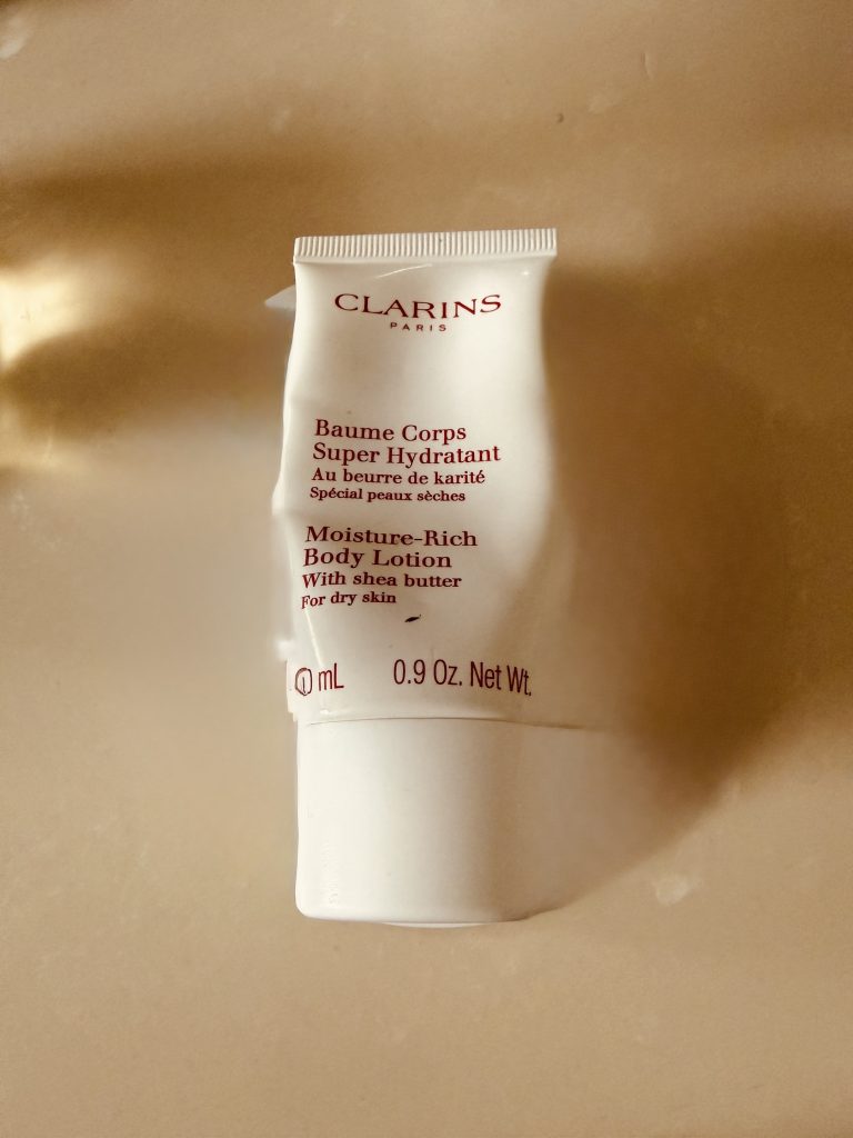 clarins small white bottle with red lettering.