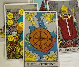 Tarot cards placed over each other. Wheel of Fortune card placed on top.