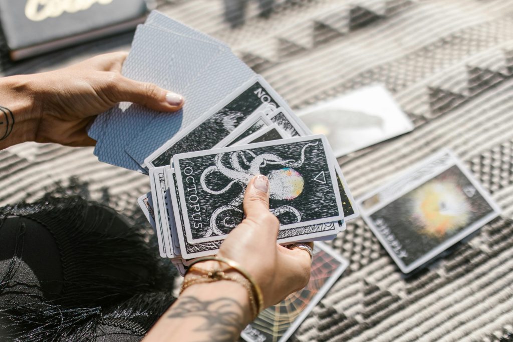 a person holding tarot cards in both hands