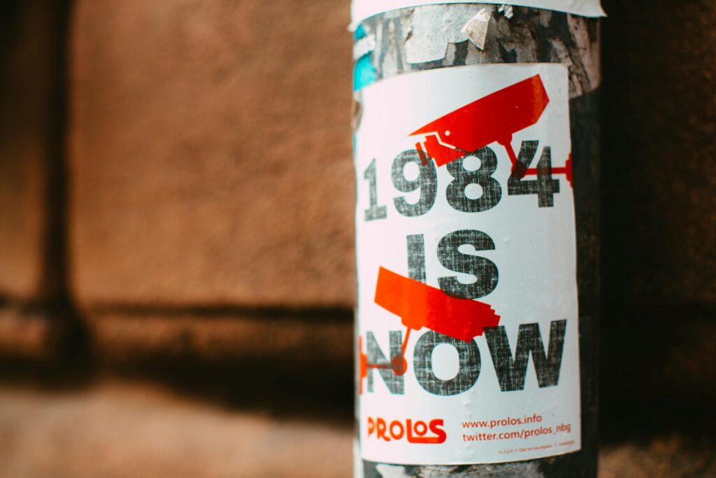 poster on a pole that says 1984 is now.