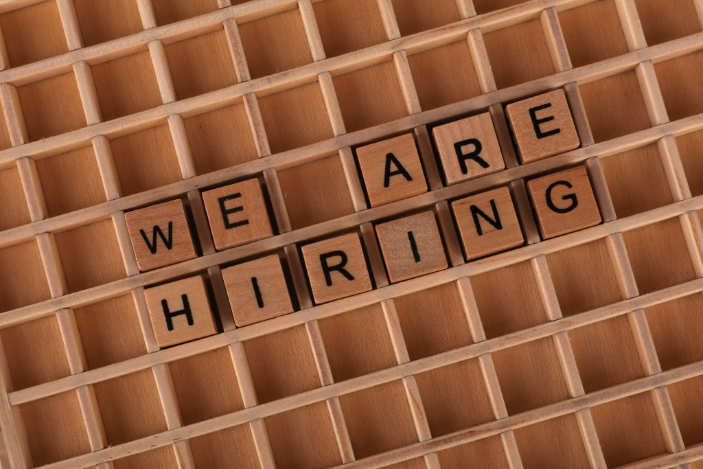 we are hiring spelled in a grid using scrabble tile letters